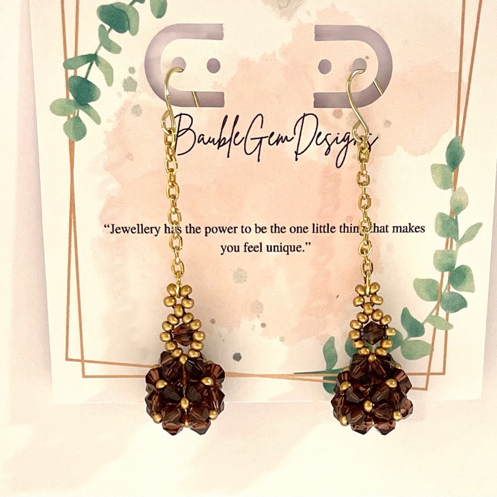 Swarovski dangling crystal disco ball earrings.
Beautiful, dark purple Beads.
